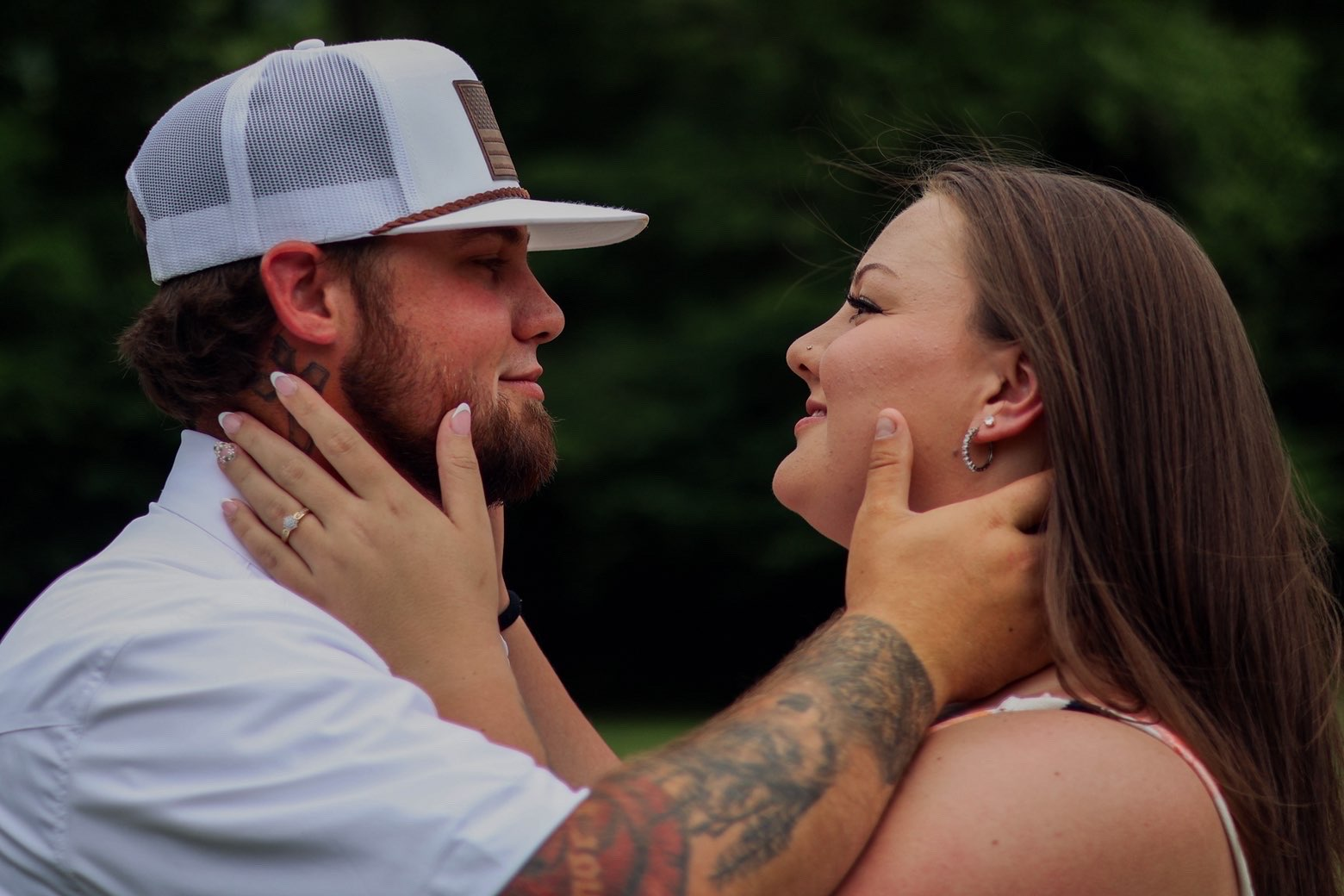 Couple holding each other's faces about to kiss