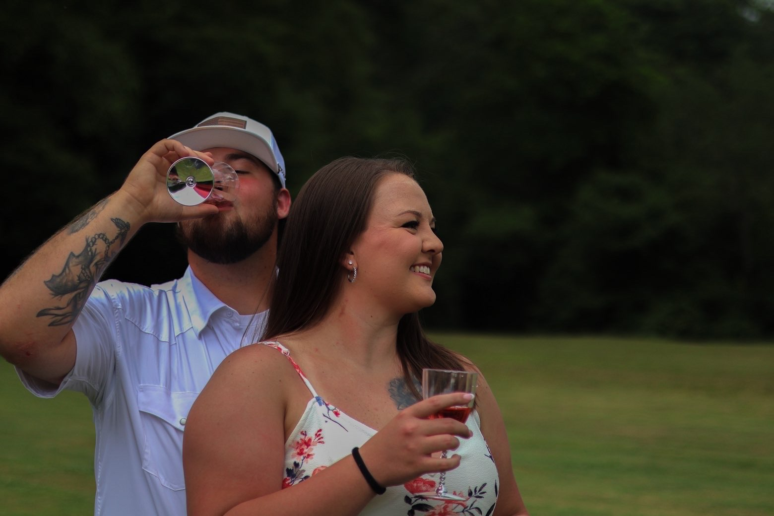 Candid moment of the couple sharing drinks and laughter
