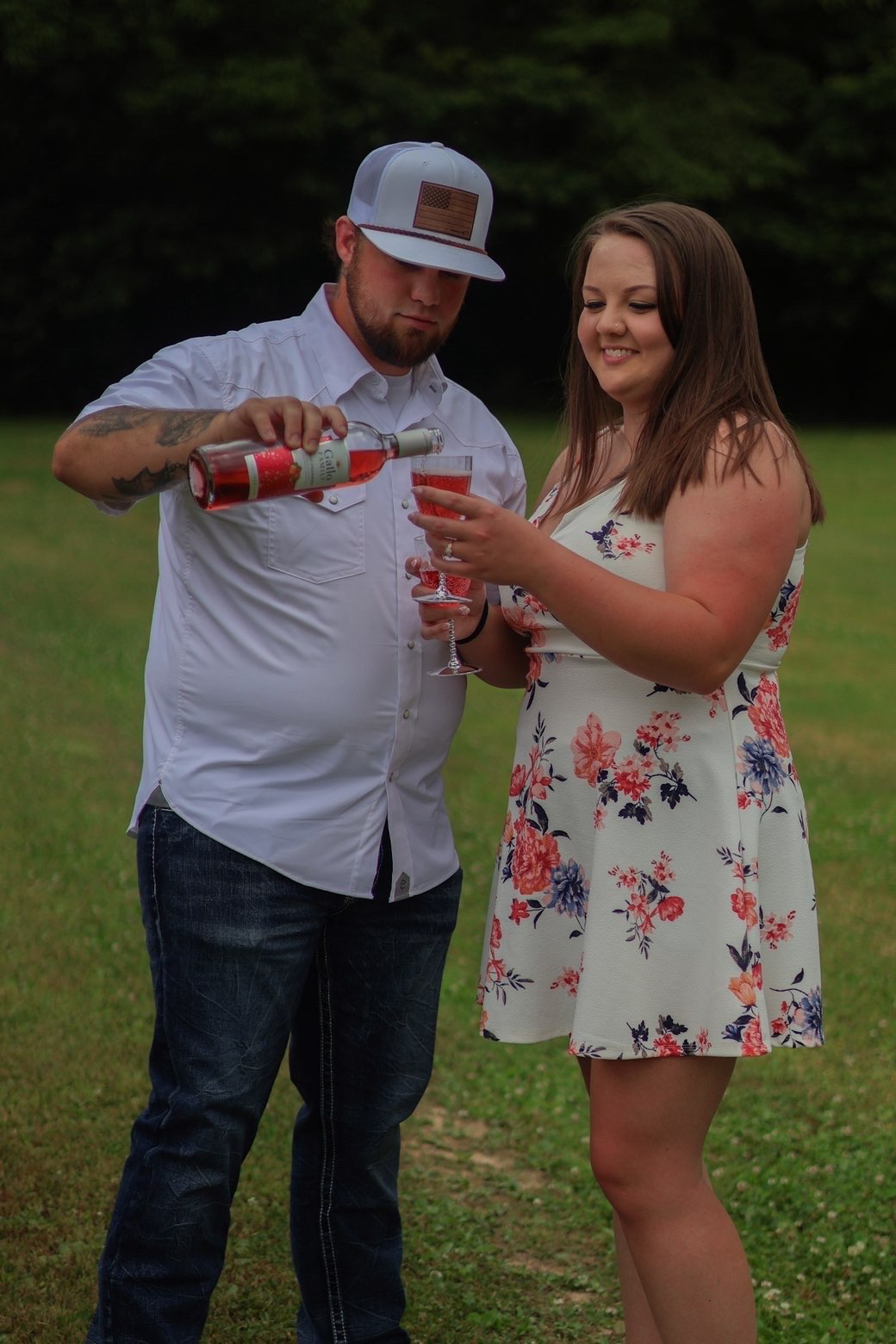Man pouring celebratory wine for his fiancee